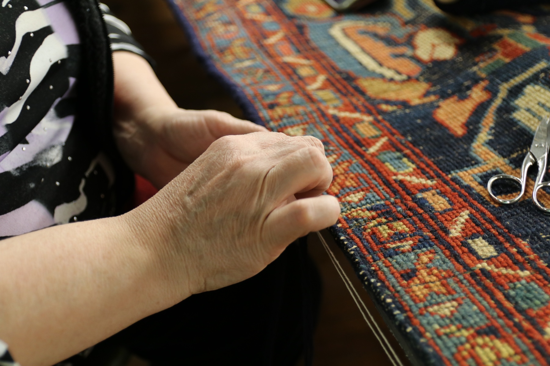 Skilled rug binding, edge repair, and hand serging by Megerian Rugs, ensuring durability and a polished finish for your rug.