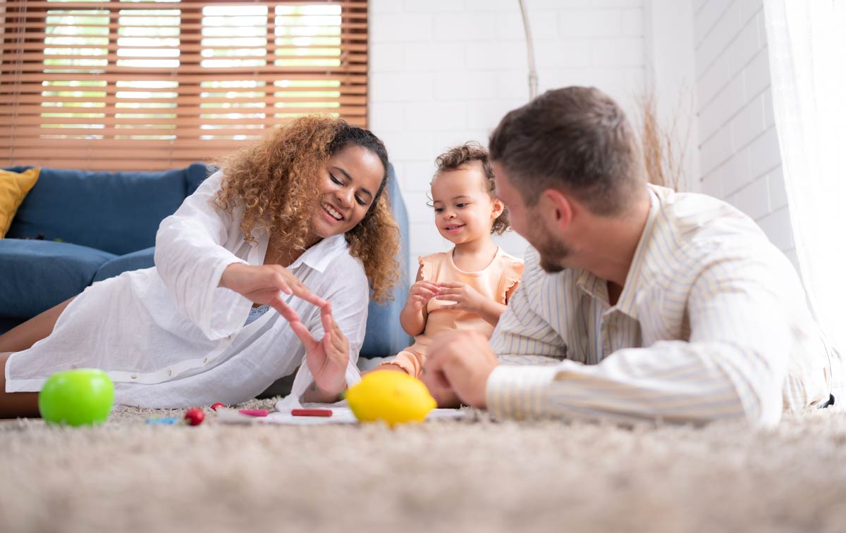 A family working together to remove a carpet stain, showcasing teamwork and care for their home environment.